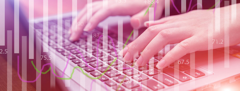 Female hands on keyboard behind transparent diagrams